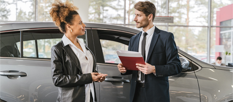 Woman with car and salesman