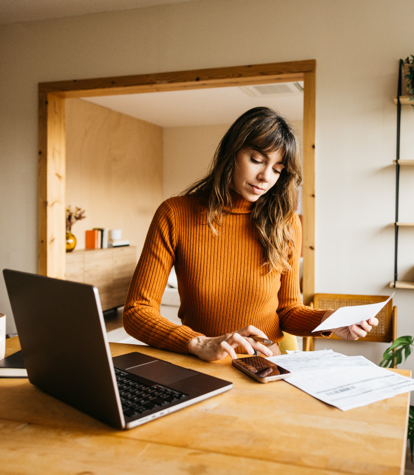girl completing bills with calculator