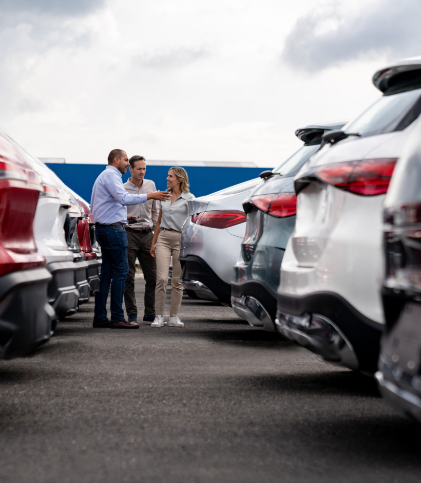 couple with dealer at car dealership