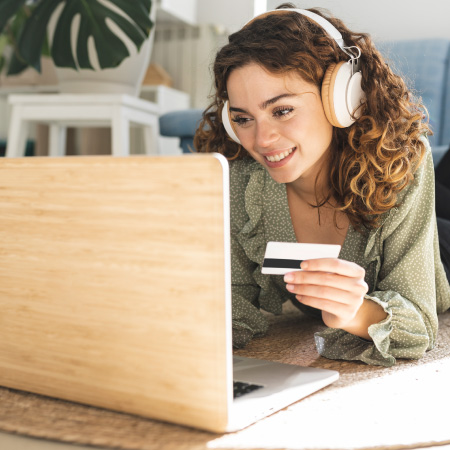 person looking at card and laptop