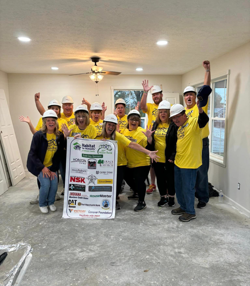 volunteers holding banner