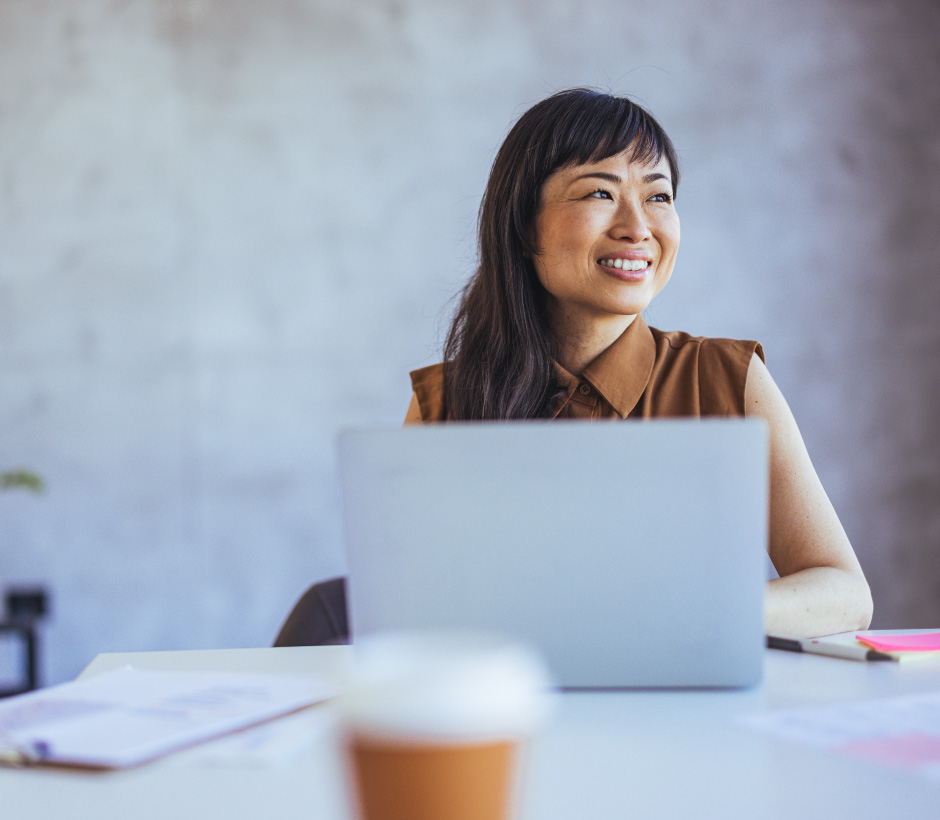 person in behind laptop