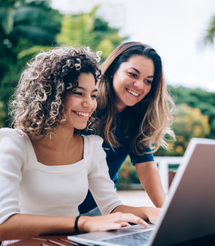 two people looking at a laptop