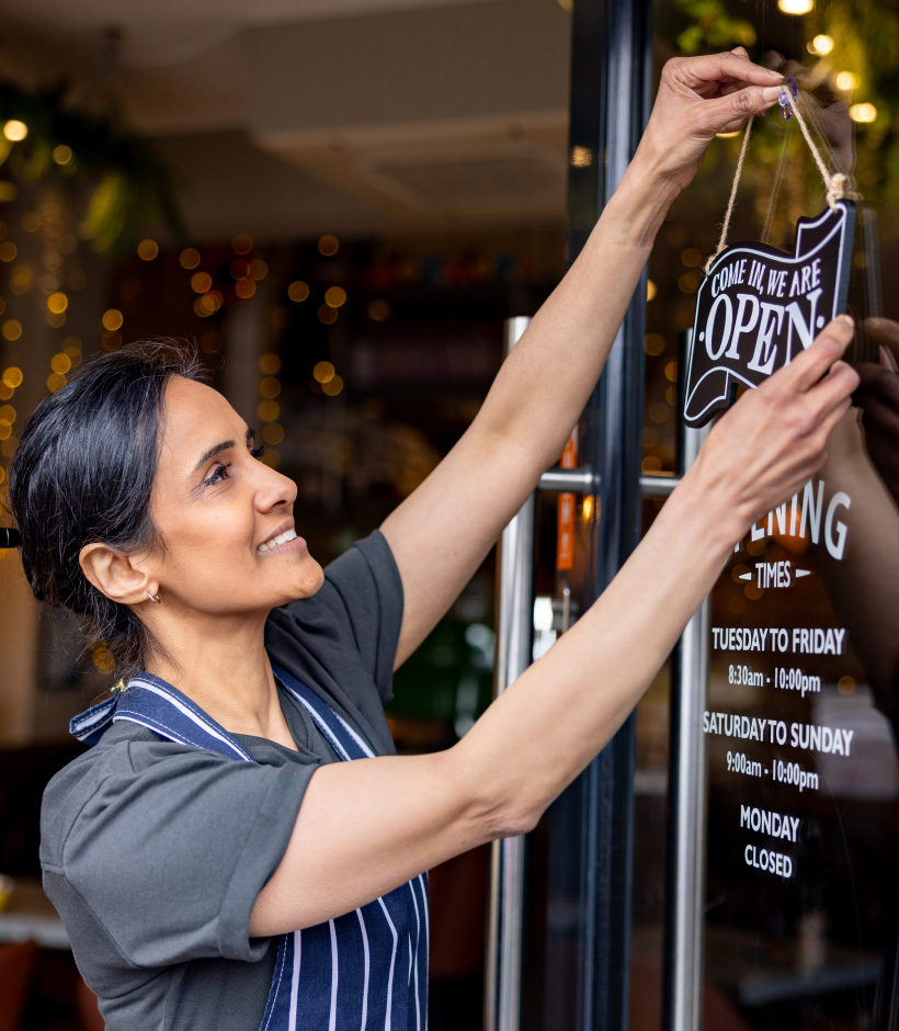Women turning open sign